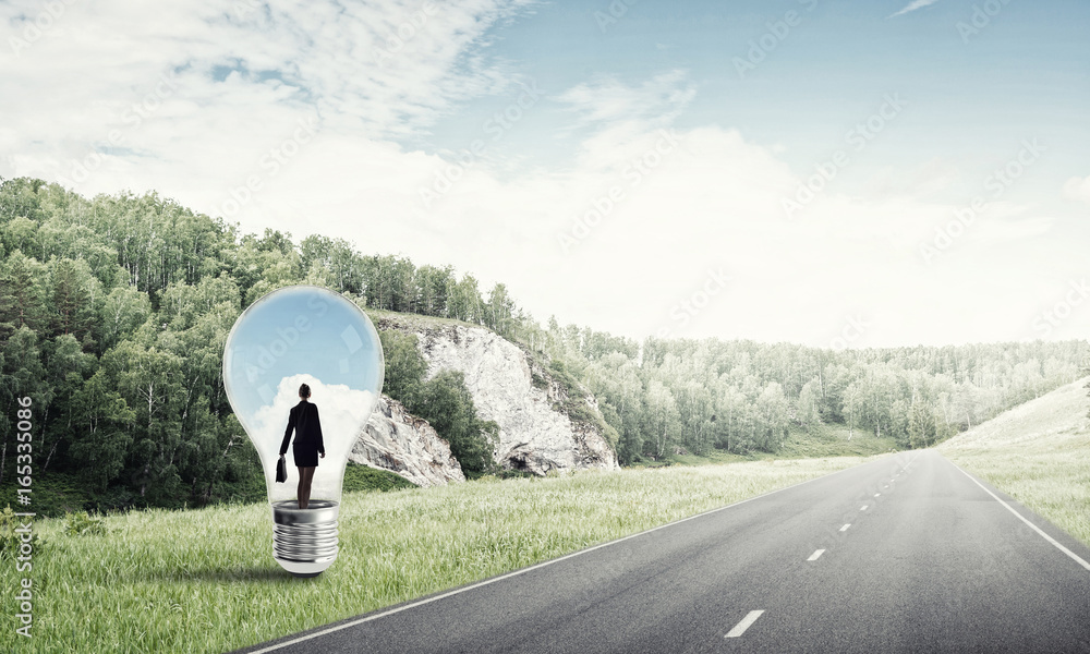 Businesswoman inside light bulb