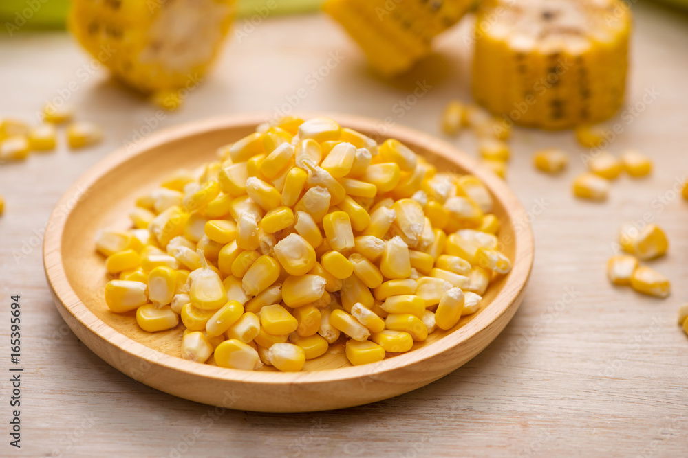 Sweet corn seeds on a wooden plate