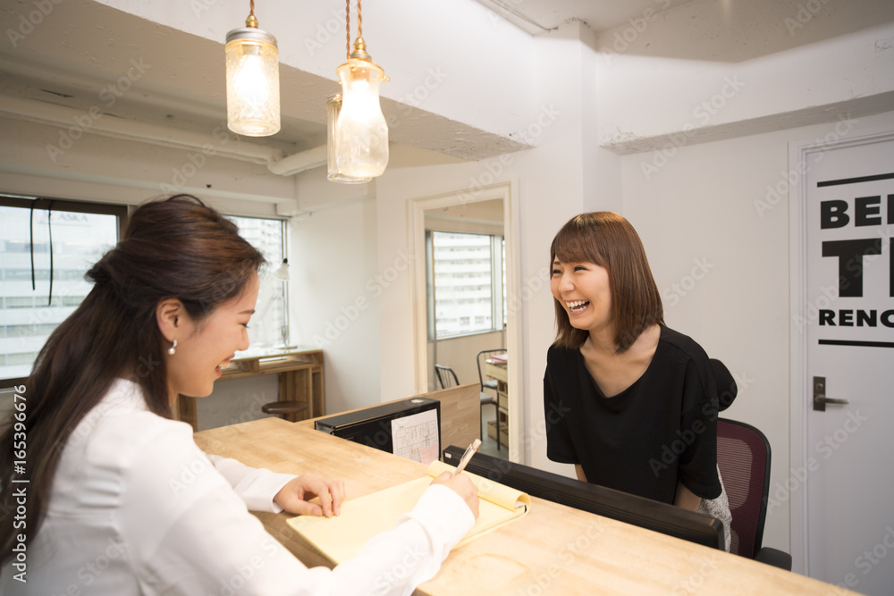 Women are having fun talking across counters