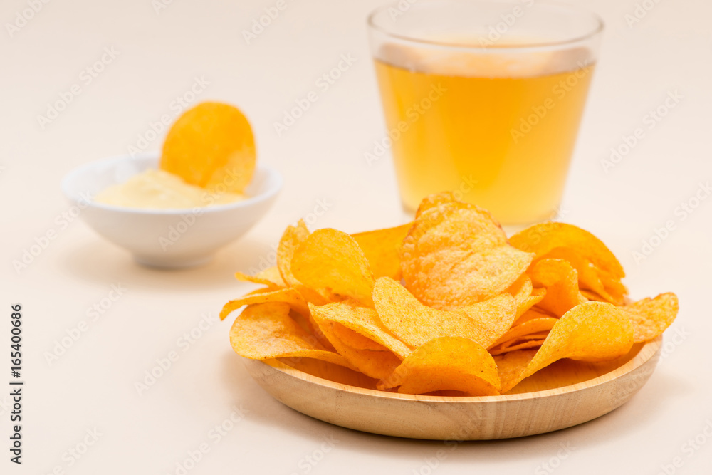 Cheese and onion potato chips with soft drink on table.