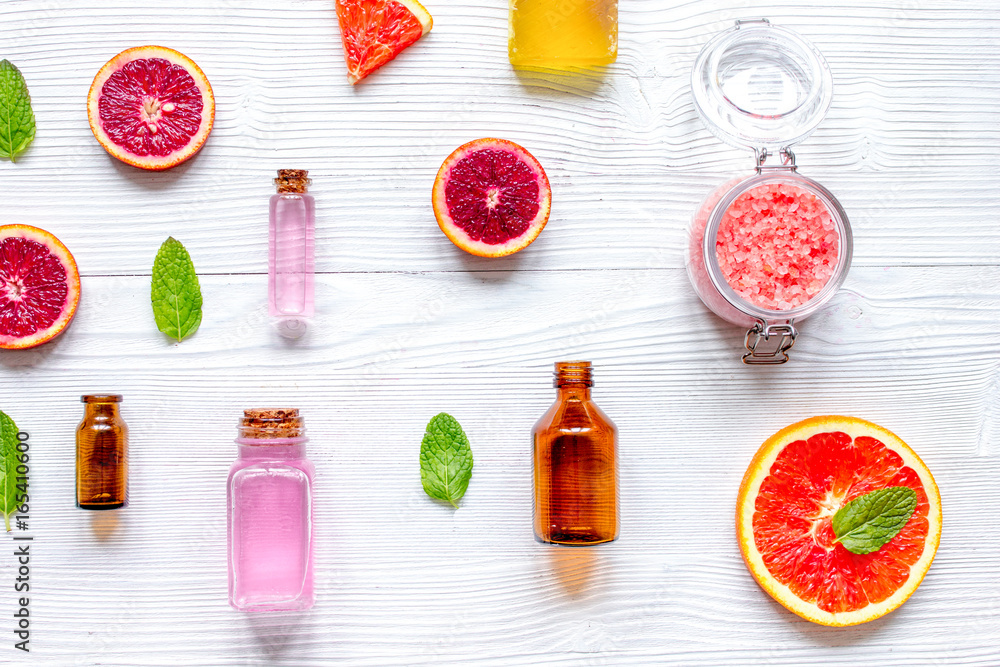 organic cosmetic with citrus on wooden background top view