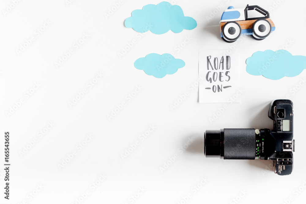 tourist equipment with toys and camera for traveling with kids on white background top view mock up