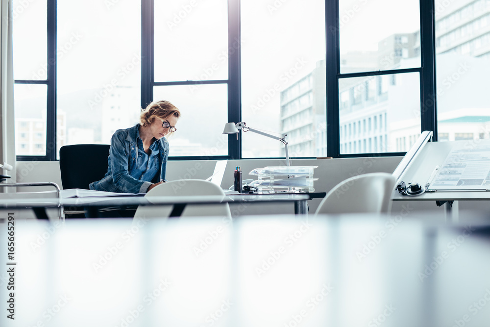 Businesswoman looking busy working on laptop