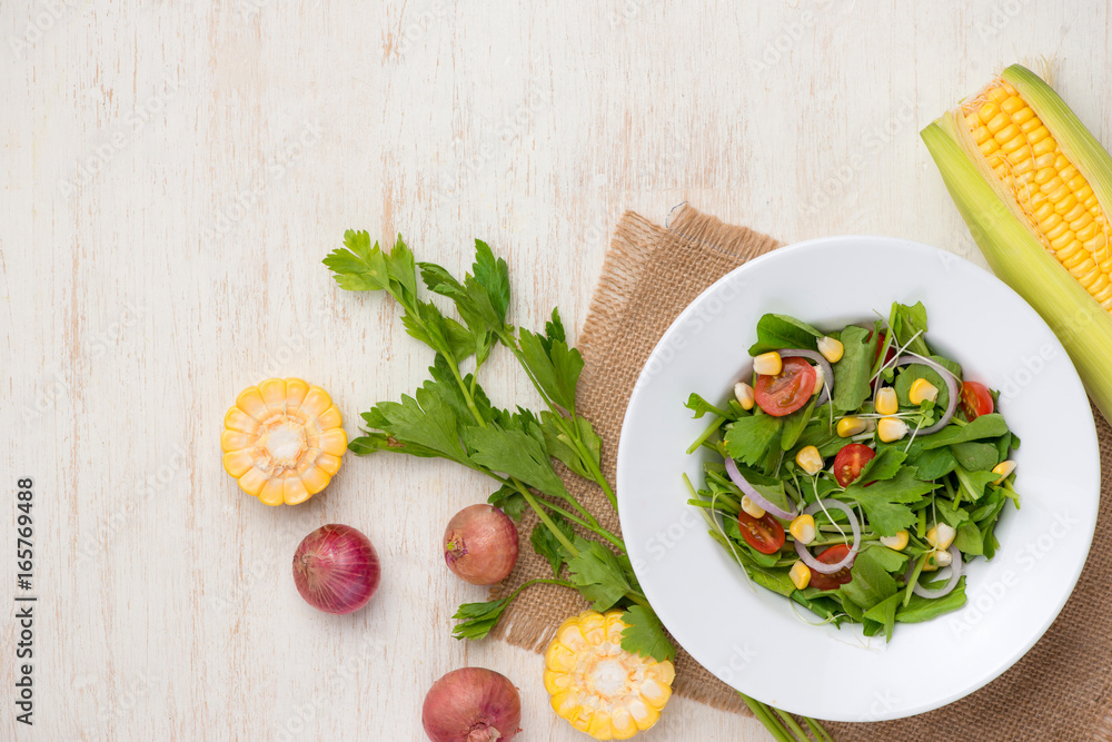 Homemade fresh green vegetable salad on table.