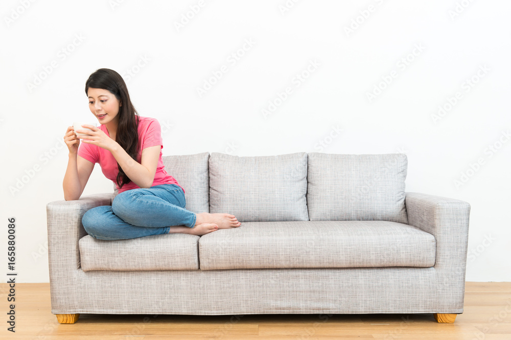 attractive sweet lady looking at hot cup mug