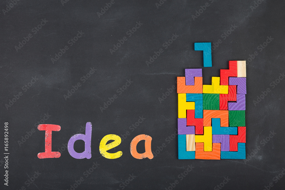 Business creative idea concept - inscription and jigsaw blocks on the blackboard