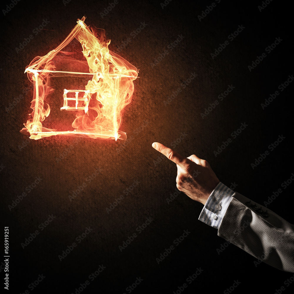 Businessman hand pointing at burning fire symbol