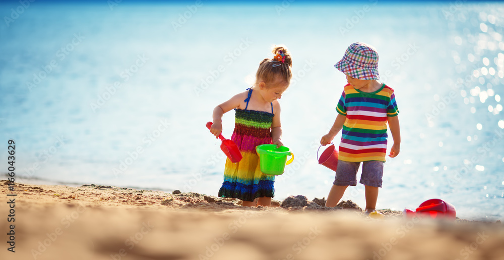 Boy and girl playing on the beach