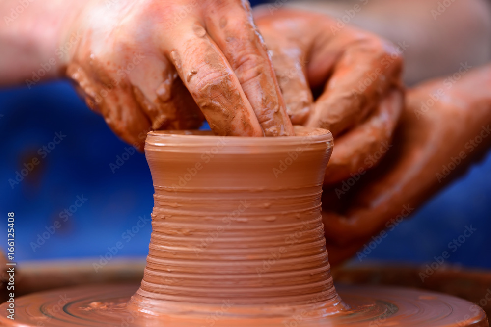 Potter making ceramic pot on the pottery wheel