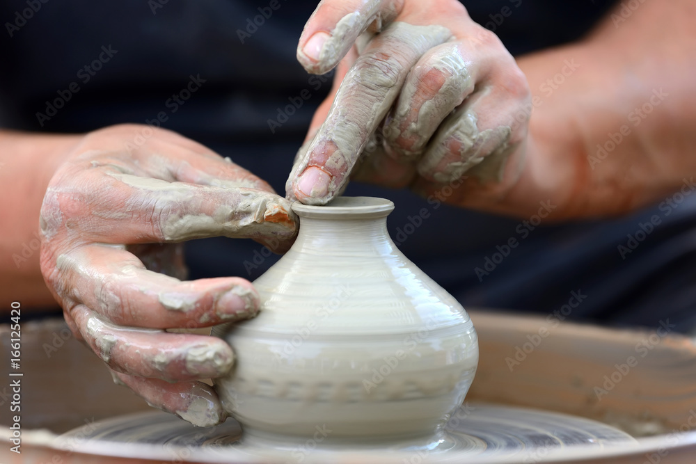 Potter making ceramic pot on the pottery wheel