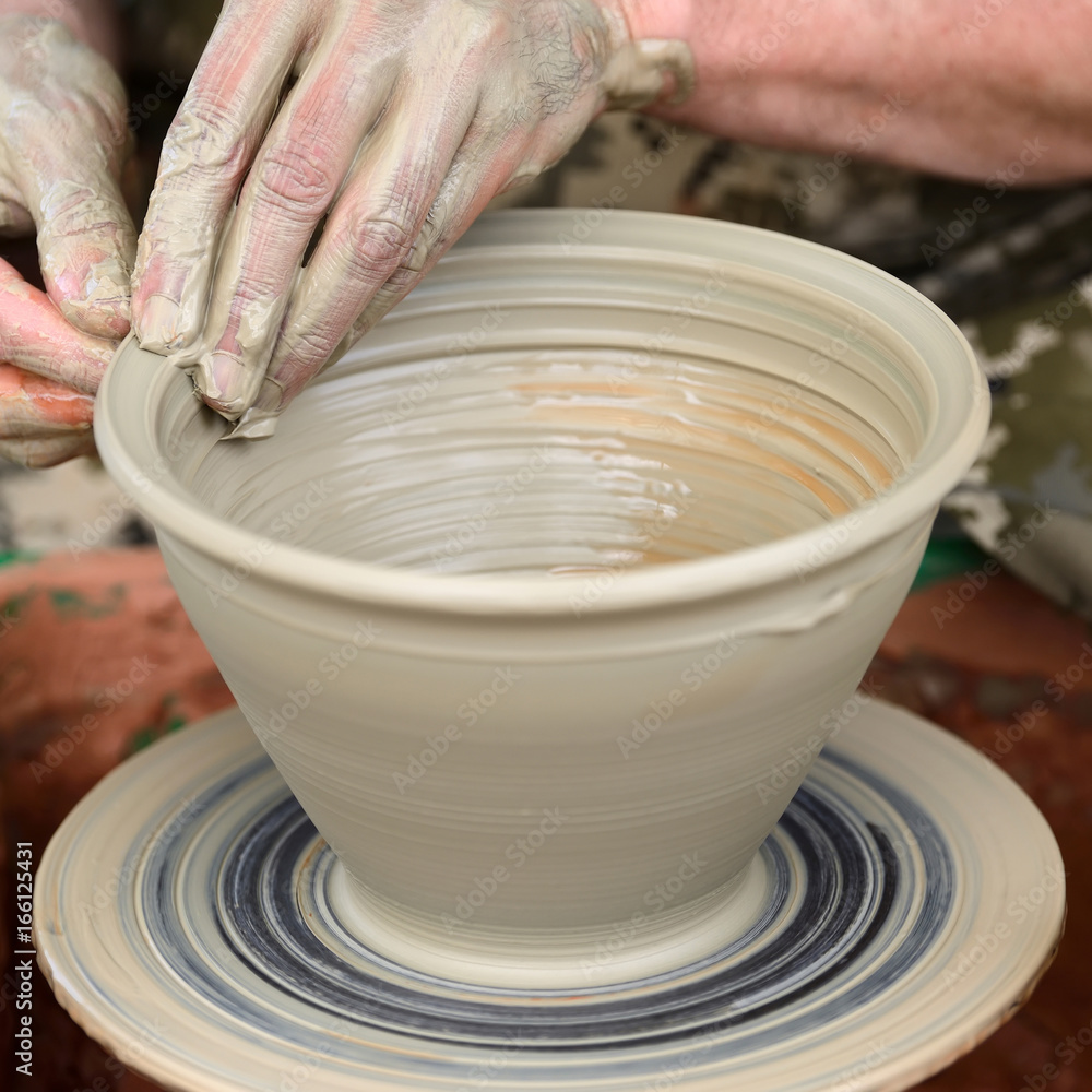 Potter making ceramic pot on the pottery wheel