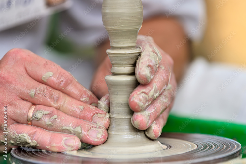 Potter making ceramic pot on the pottery wheel