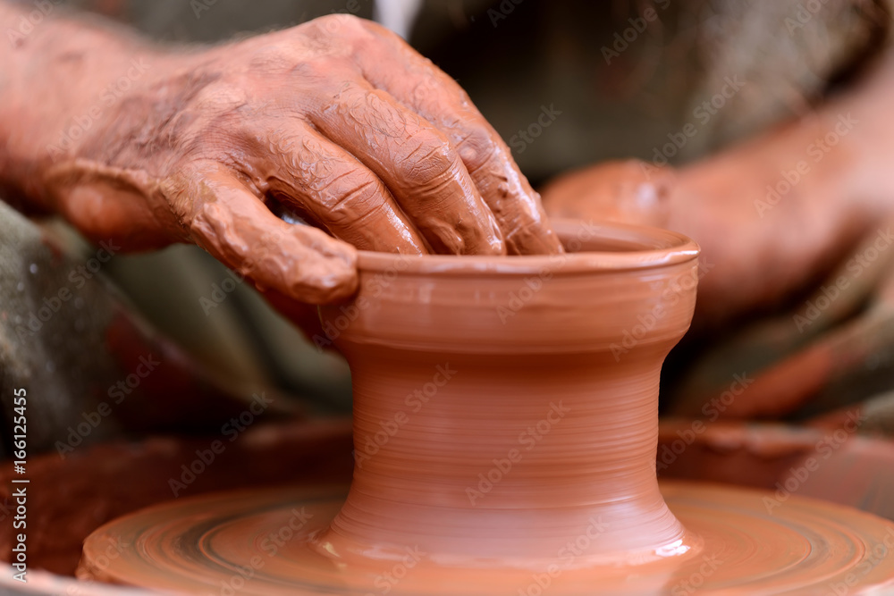 Potter making ceramic pot on the pottery wheel