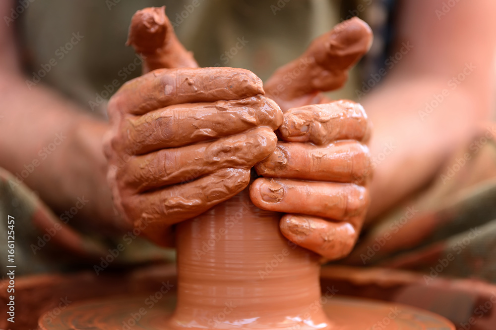 Potter making ceramic pot on the pottery wheel