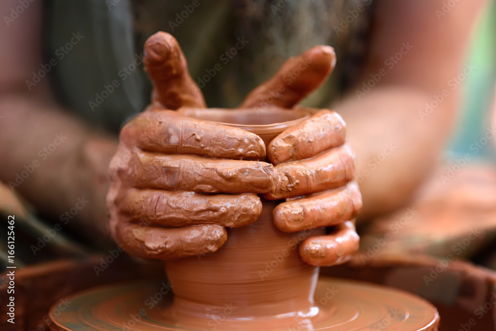 Potter making ceramic pot on the pottery wheel