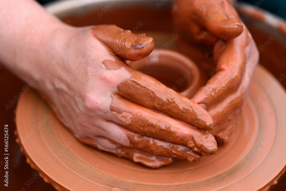 Potter making ceramic pot on the pottery wheel