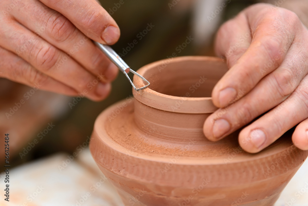 Potter making ceramic pot on the pottery wheel