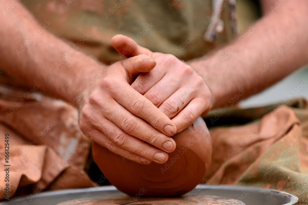 Potter making ceramic pot on the pottery wheel