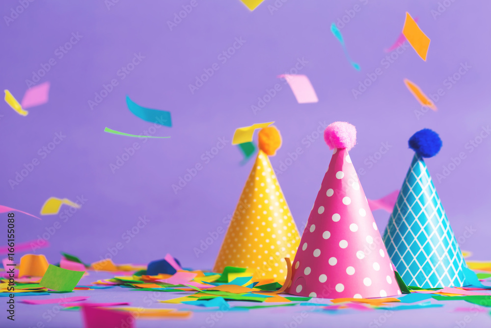 Party hat celebration theme with confetti on a bright background