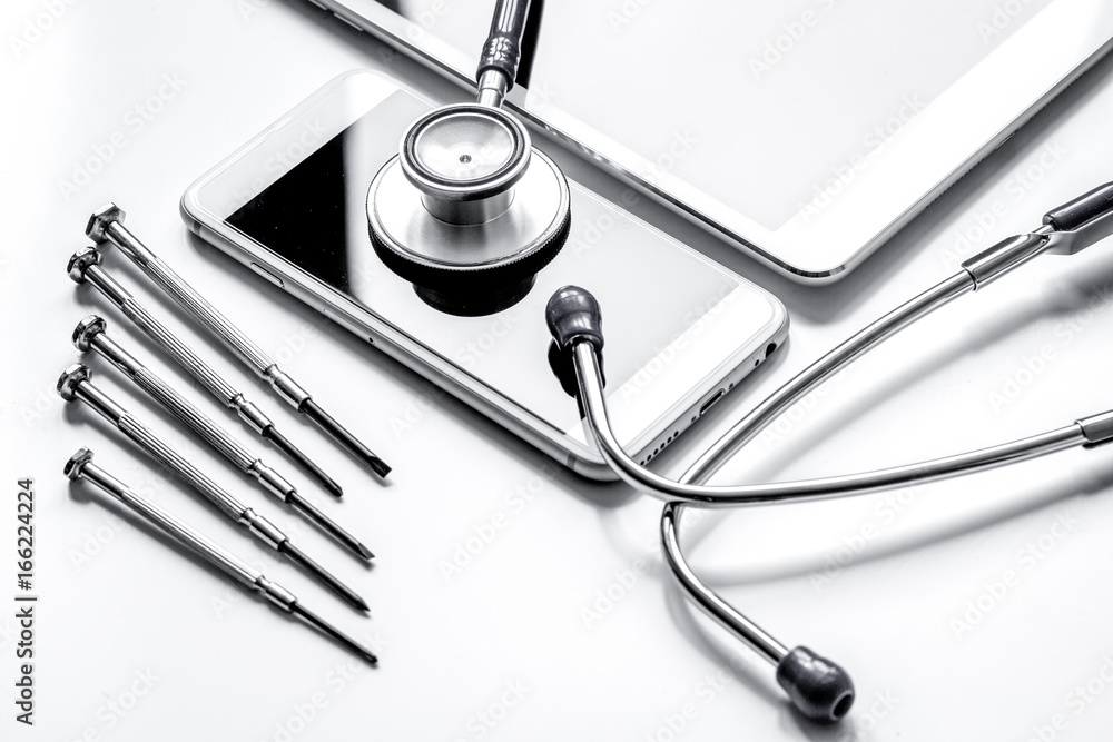 diagnostic of gadgets on white background with stethoscope