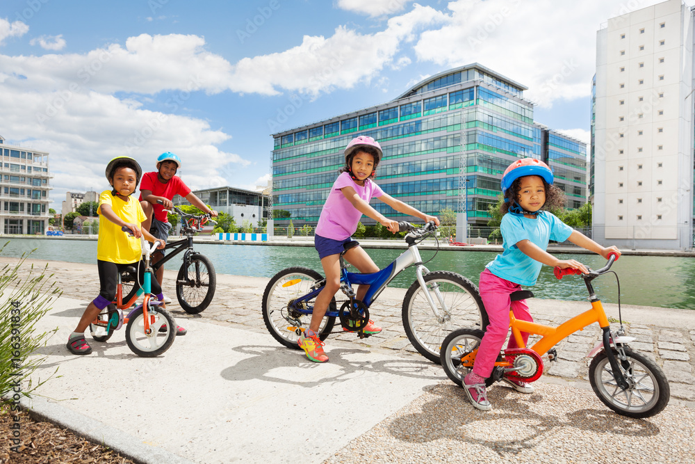 African children enjoying cycling together in town