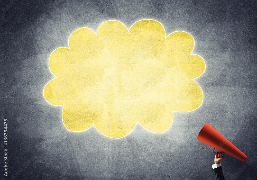 Hand of businesswoman holding red paper trumpet and speech cloud