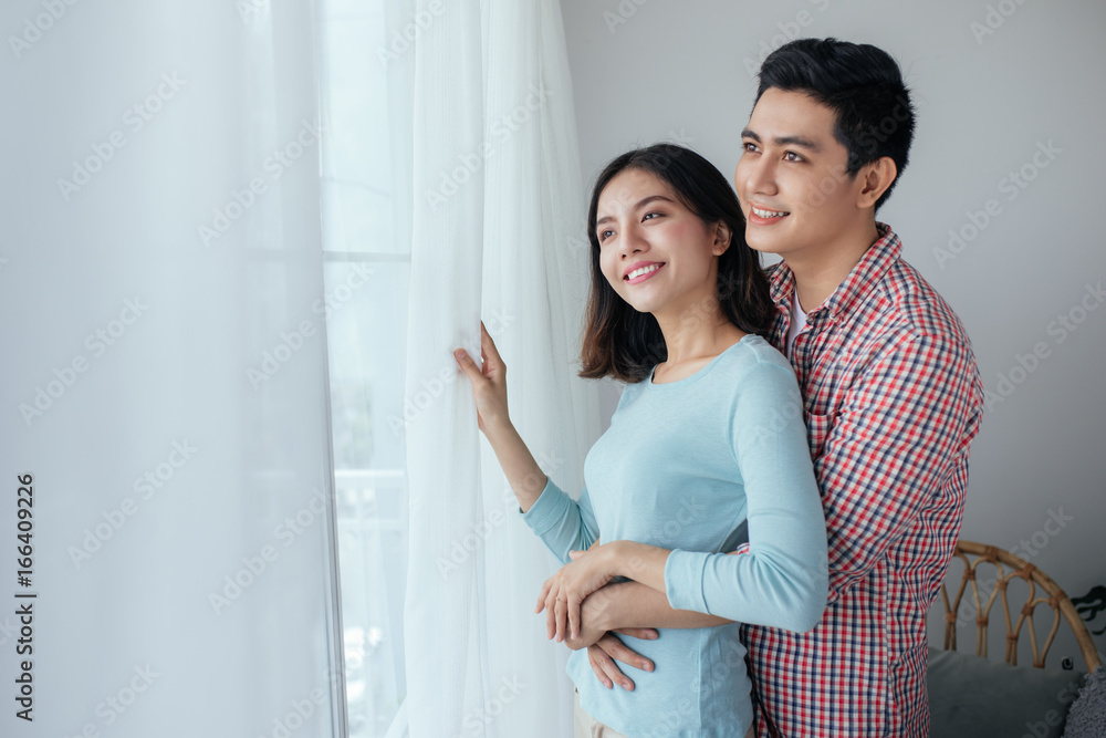 Romantic happy young asian couple relax at modern home indoors