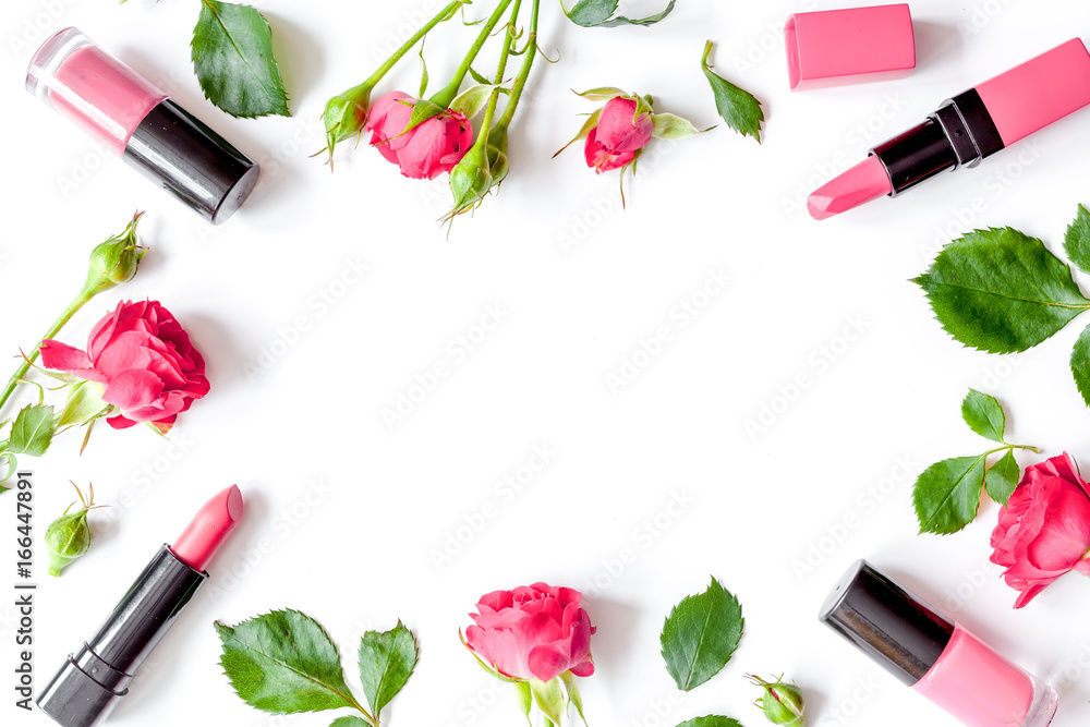 berry color decorative cosmetics with roses white background top