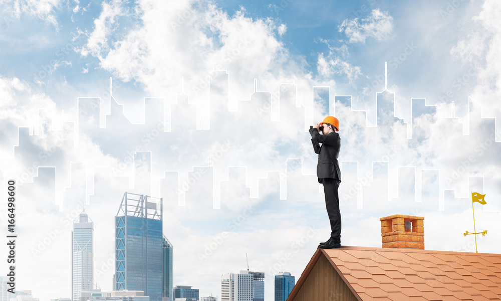 Engineer man standing on roof and looking in binoculars. Mixed media