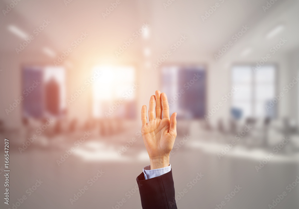 Choosing gesture of businessperson in elegant modern interior in sunshine light