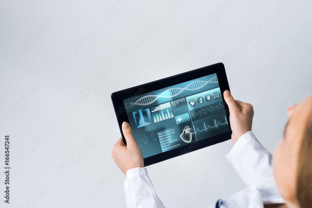 Close of female doctor hands working with tablet pc computer