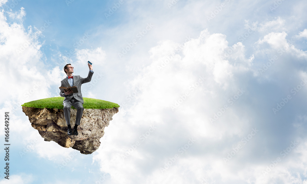 Young businessman or student floating in sky and studying the science