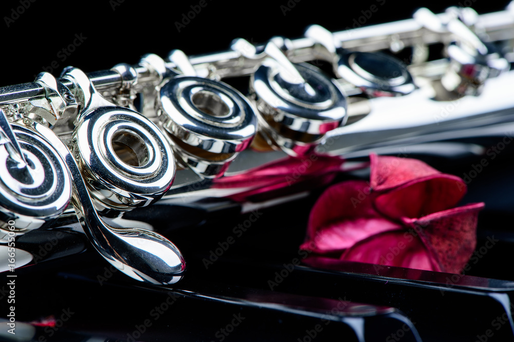 jazz music instrument flute close up with flower isolated on black background