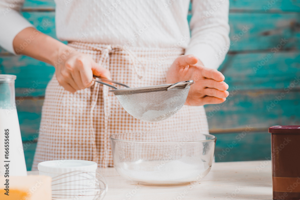 House wife wearing apron making. Steps of making cooking chocolate cake.