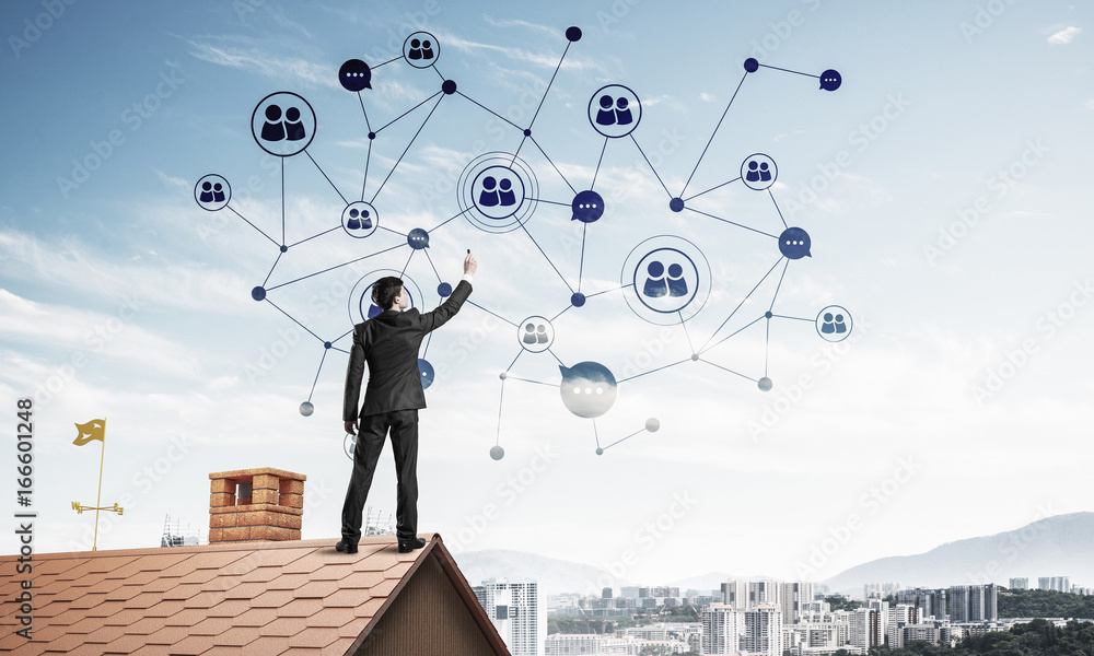 Businessman on house roof presenting networking and connection c