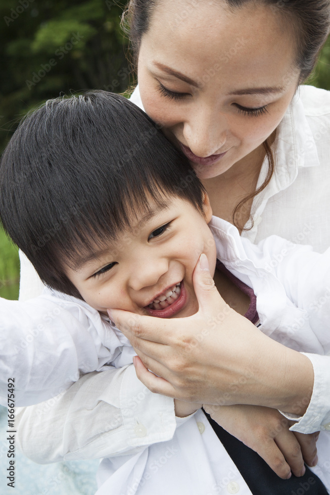 Mom and son are playing in the park