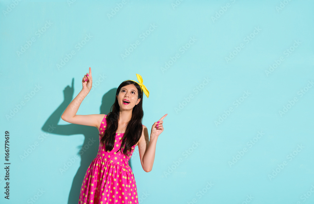 chinese woman pointing to the top blue background