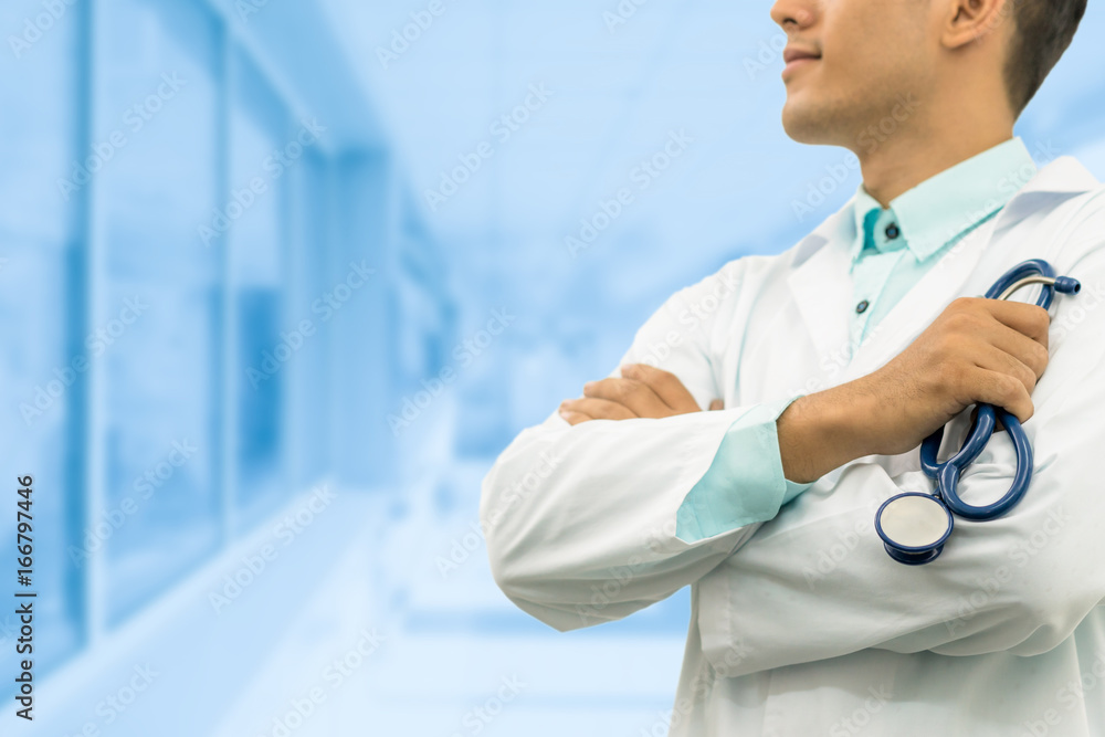 Male doctor holding stethoscope in the hospital