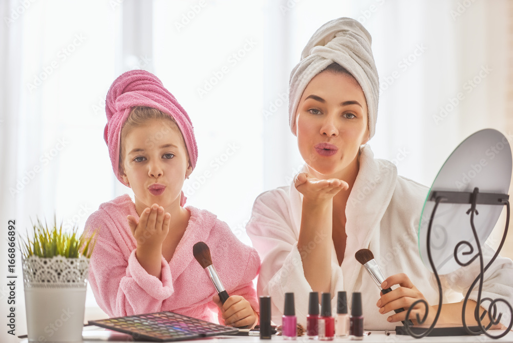 Mother and daughter are doing make up