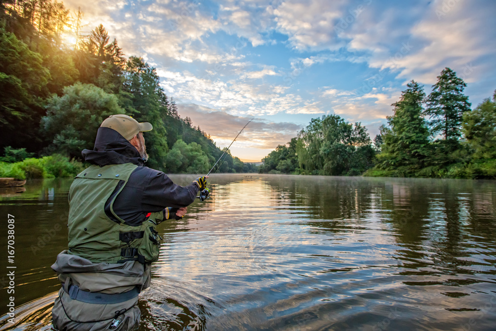 Sport fisherman hunting fish. Outdoor fishing in river