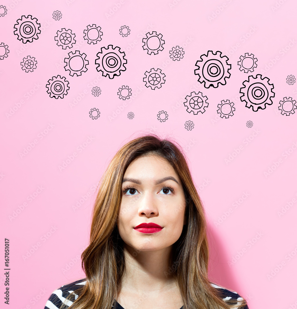 Gears with young woman on a pink background