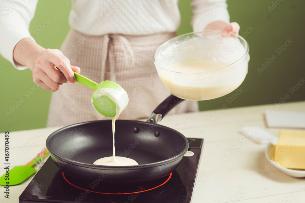 House wife wearing apron making. Steps of making cooking apple cake. Cutting green apple.