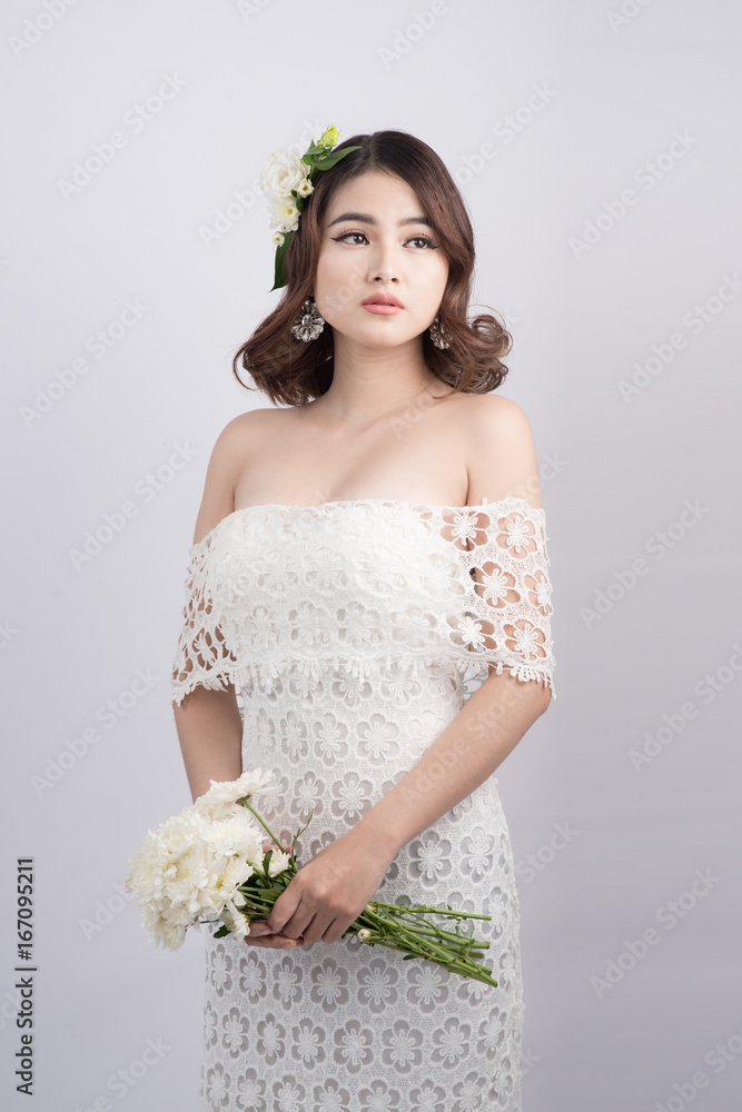 Beautiful asian woman bride on grey background. Closeup portraits with a professional makeup