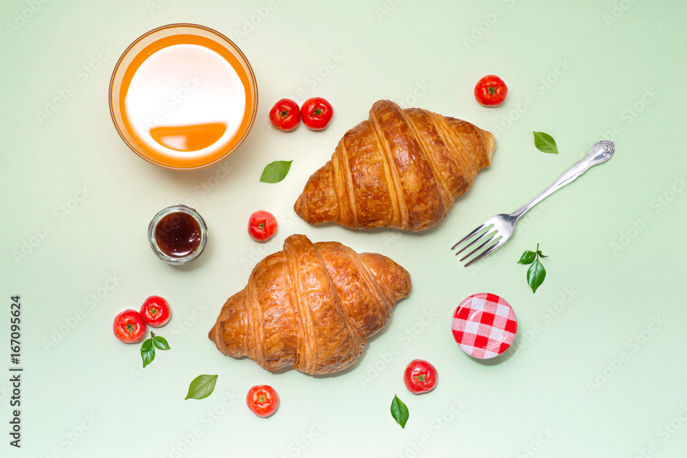 Breakfast with fresh croissants and orange juice, top view