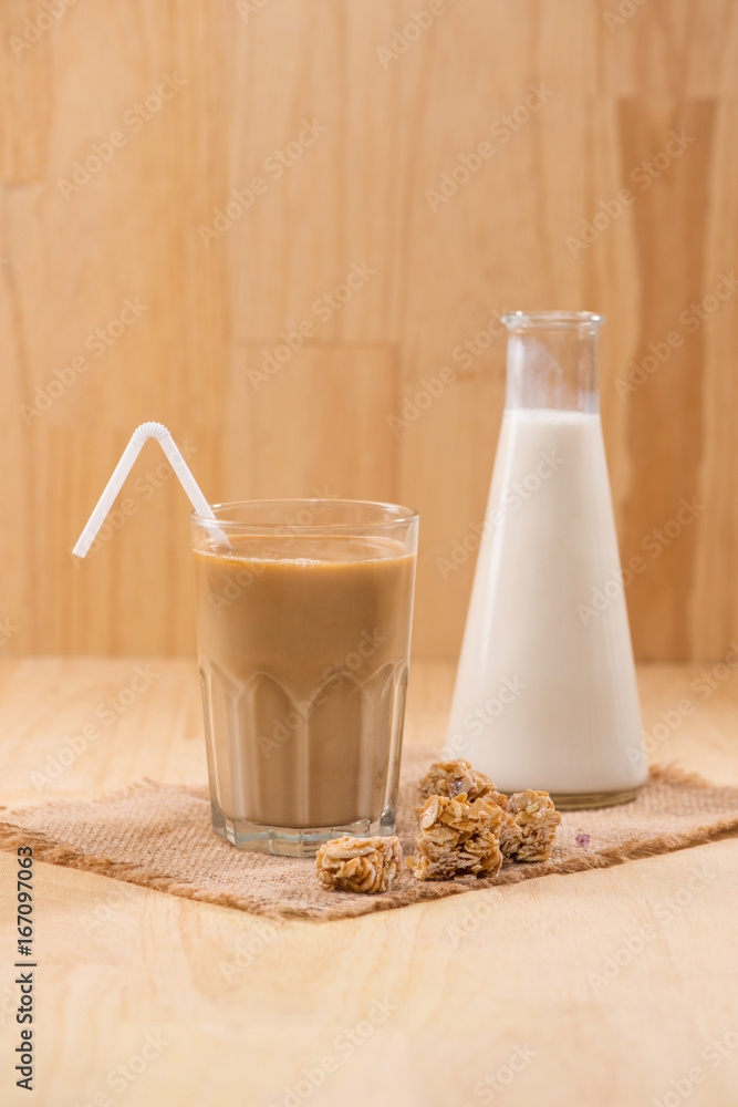 Coffee with milk on a wooden table.