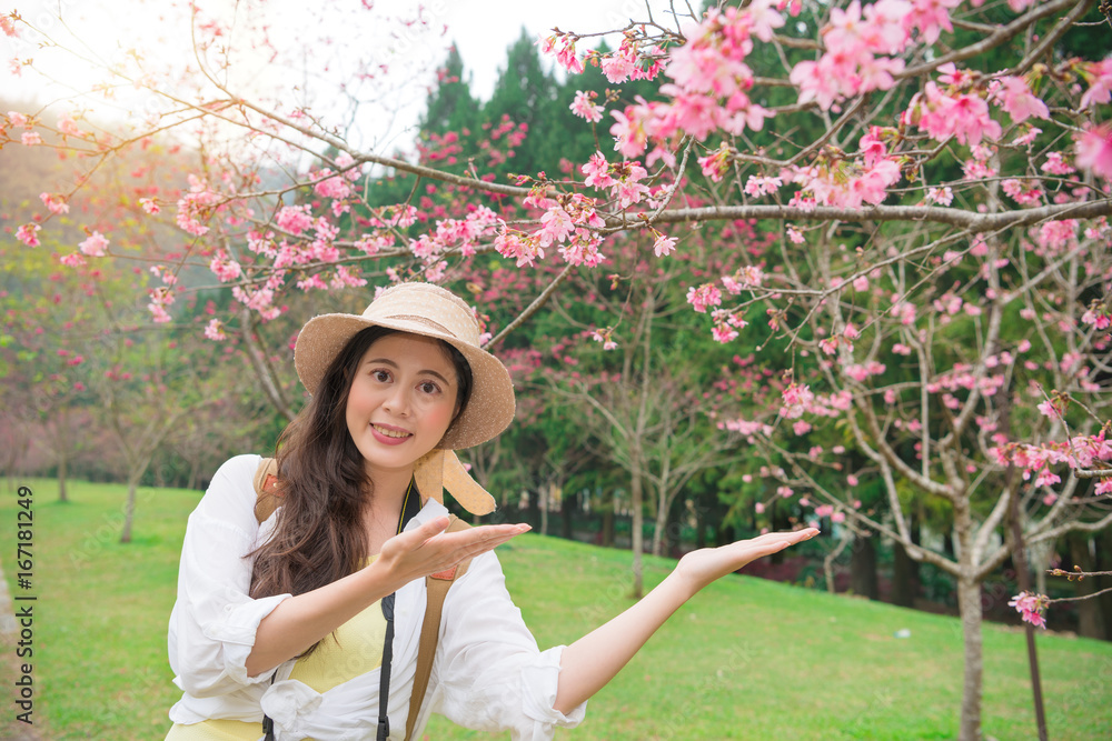 美丽的女性旅行者做出展示姿势