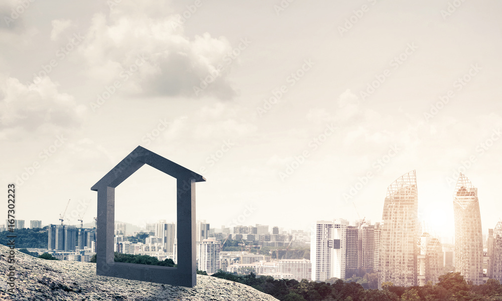 Conceptual image of concrete home sign on hill and natural lands