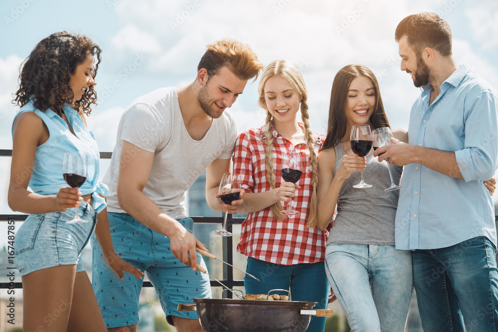 Group of friends having barbecue party on the roof