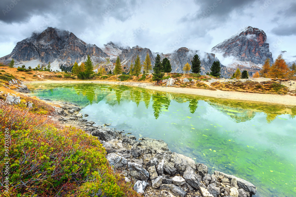 Fantastic alpine lake with high peaks in background, Dolomites, Italy