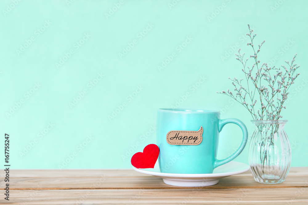 Coffee cup mug with red heart shapeand happy word tag on wooden table , Romance and love valentines 